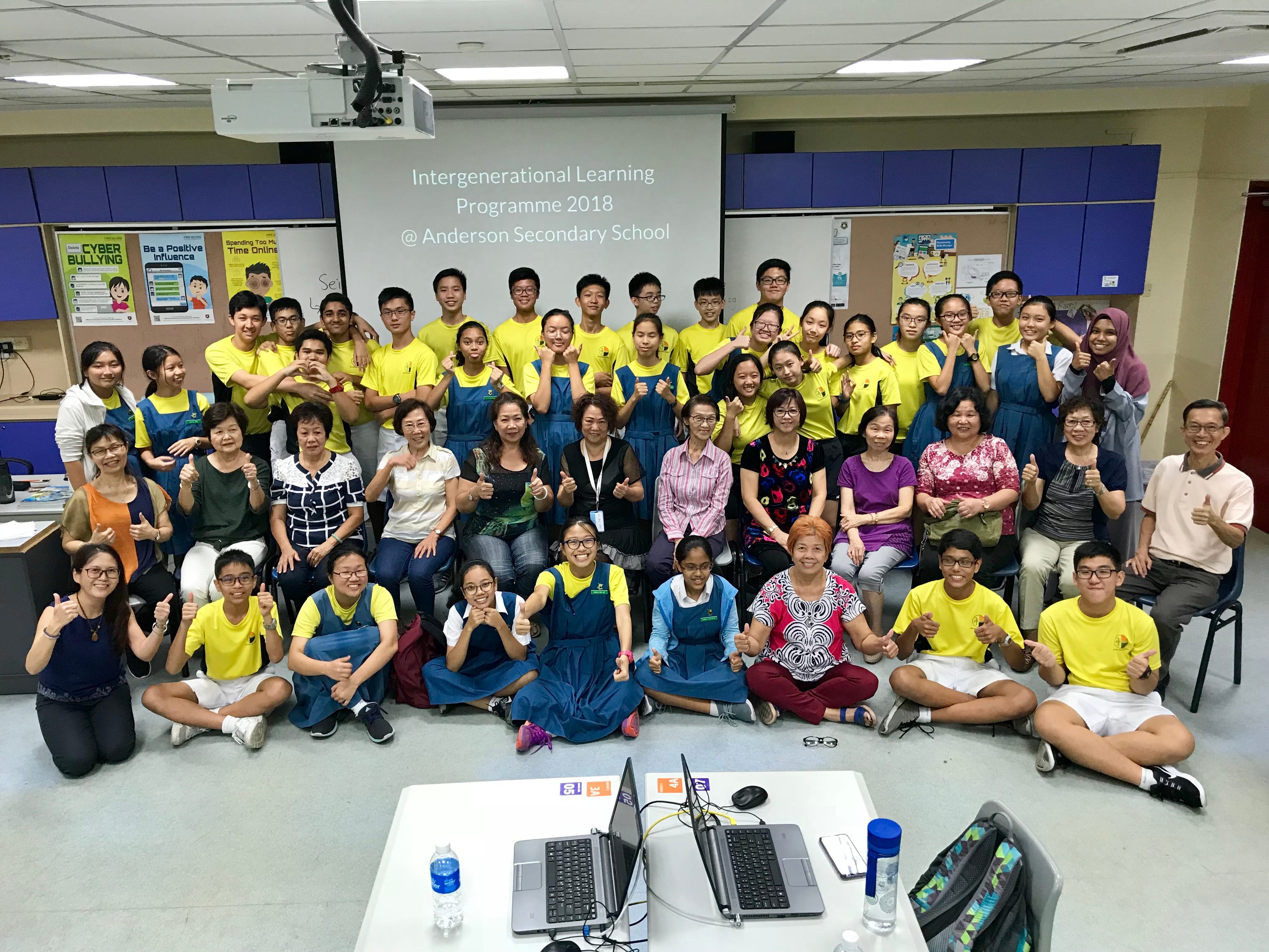 Large group posing in a classroom for the Intergenerational Learning Programme 2018 at Anderson Secondary School.